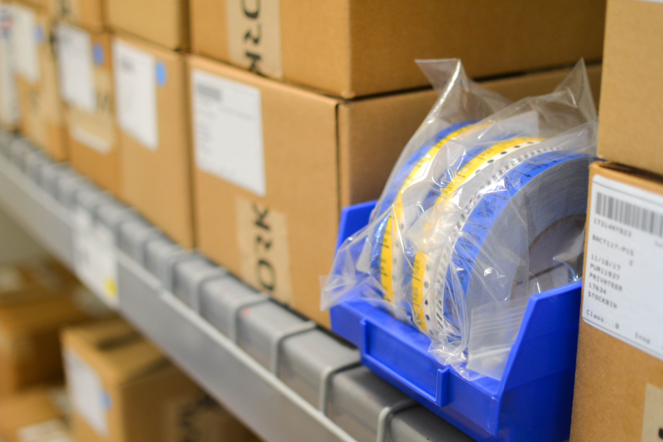 Orkal, 1. Orkal Industries electronic components reel amidst packed boxes, poised for top-tier aerospace assembly solutions.
2. Warehouse shelf showcasing the versatile range of Orkal tooling for reliable aircraft-grade fluid transfer systems.
3. Compliance-ready electronic components by Orkal Industries nestled among other supplies awaiting efficient logistic support.
4. High-quality Orkal tooling essentials displayed alongside packaged boxes, promising aviation-grade repair and maintenance fittings.
5. Assembly-focused view of an organized warehouse shelf hosting high compliance, Aerospace Quality component reels from Orkal Industries.